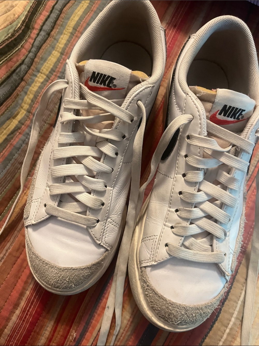 Nike Men’s White Leather Sneakers with Red Swoosh Accent